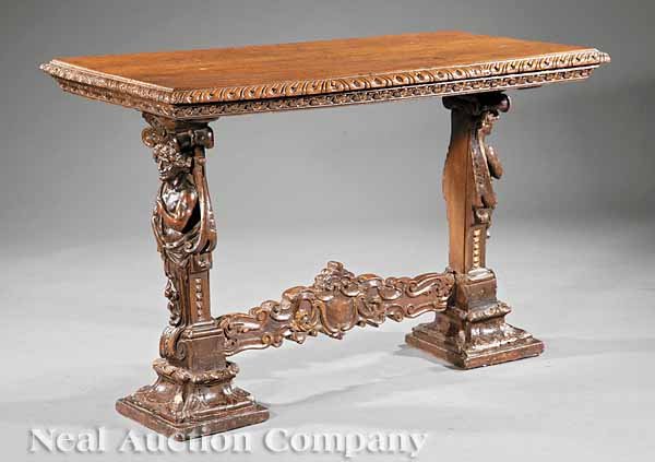 Carved Walnut Console Table: A Continental Baroque Carved Walnut Console Table, 17th c., composed of antique elements, gadrooned top, figural supports, medial stretcher, leaf-carved blocked feet, height 27 3/4 in., width 41 3/4 i