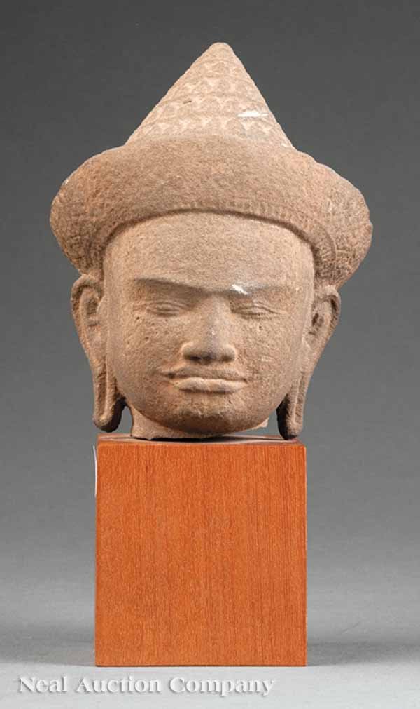 Southeast Asian Carved Sandstone Buddha: An Antique Southeast Asian Carved Sandstone Head of Buddha, Khmer (Cambodia) Angkor style, buff stone carved head with a meditative down-turned face flanked by elongated ears and topped with a tall co