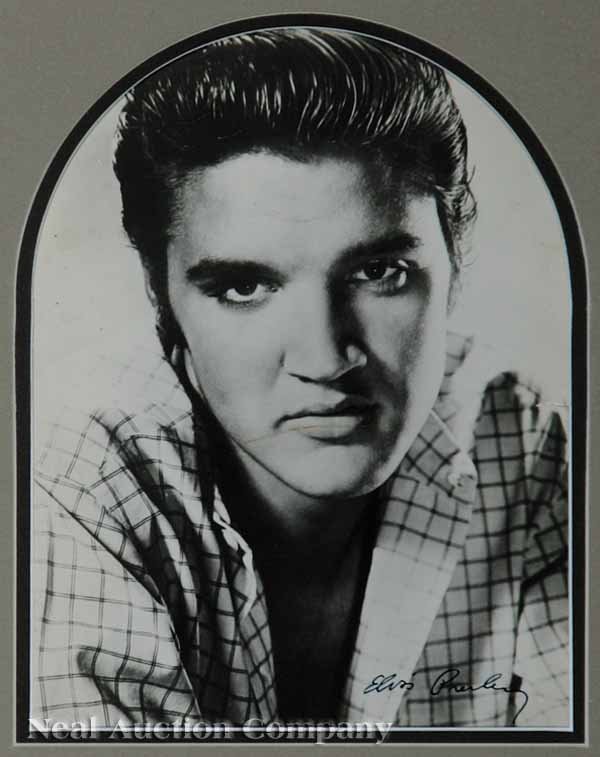 Autographed Photograph of Elvis Presley: An Autographed Photograph of Elvis Presley, signed lower right, sight 8 1/2 in. x 6 1/4 in., matted and framed with a letter from the previous owner