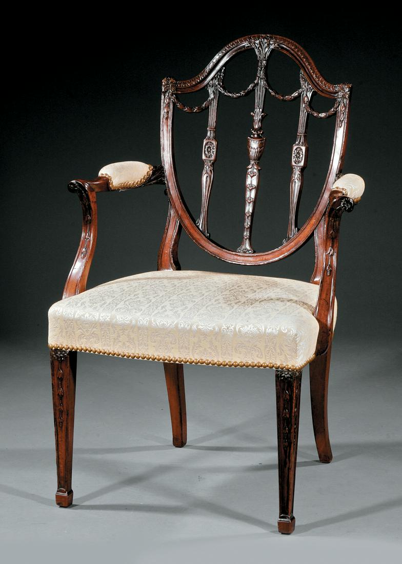 George III Carved Mahogany Armchair: George III Carved Mahogany Armchair in the Hepplewhite Manner , c. 1790, shield back, arched crest centering an acanthus spray, bellflower pendant stiles and swags, padded arms, serpentine seat, squar