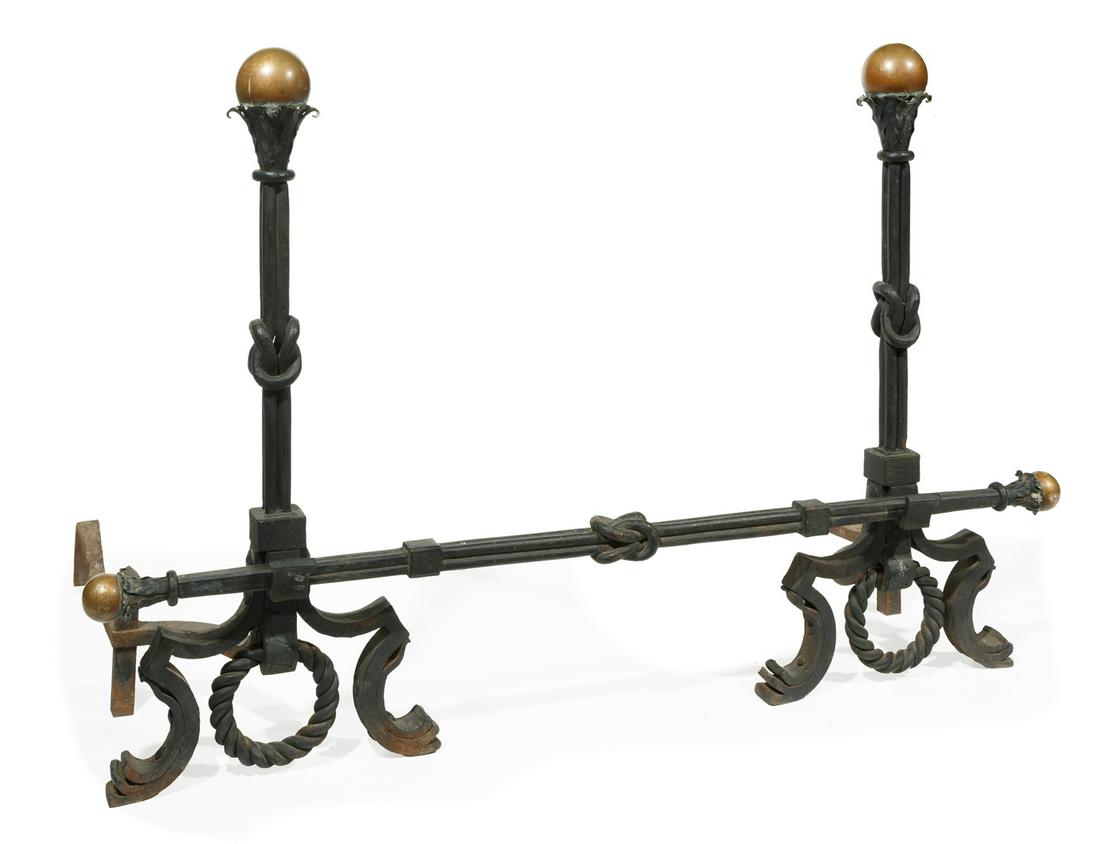 Continental Wrought Iron and Bronze Andirons: Pair of Continental Wrought Iron and Bronze Andirons , with "knotted" standard and crosspiece, h. 40 in., w. 18 in., d. 38 in., crosspiece l. 60 in. Note: One leg rest with loss