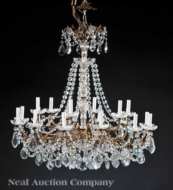 Pair Gilt Bronze and Glass Chandliers: A Pair of Louis XV-Style Gilt Bronze and Glass Eighteen Light Chandliers, 20th c., scrolled supports, hung with swags and prisms, height 30 in., diameter 33 in