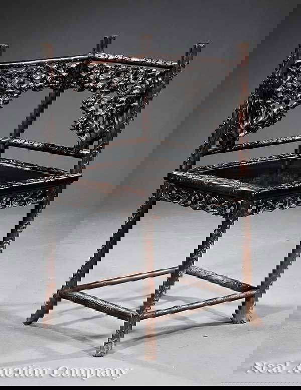 Chinese Carved Hardwood Corner Chair: A Chinese Carved Hardwood Corner Chair, possibly Zitan, the pierced splat of blossoming tree design, similar carved seat rail, naturalistic carved legs joined by stretchers ending in hoof feet