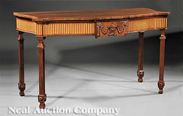 George III-Style Inlaid Mahogany Serving Table: A George III-Style Inlaid Mahogany Serving Table, serpentine top, blocked center drawer with urn and husk swags, the beaded skirt with satinwood inlaid flutes, raised on blocked and fluted square legs