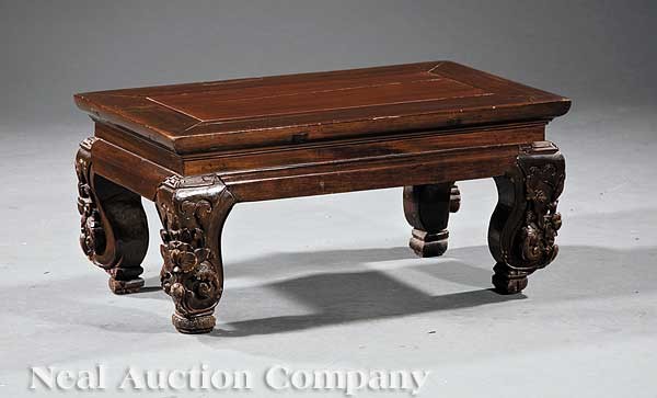 Chinese Carved Wood Rectangular Footstool: A Chinese Carved Wood Rectangular Footstool, probably Zitan or Hongmu, the molded top on floral carved cabriole legs on scrolled feet, height 12 1/2 in., length 26 3/4 in., width 15 3/8 in
