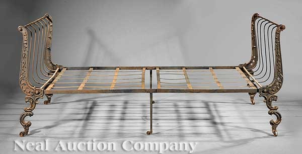 French Cast Iron Campaign Bed: An Antique French Cast Iron Campaign Bed, 19th c., scrolled uprights, slatted frame, leaf and scroll legs, casters, height 33 1/2 in., length 60 in., width 44 in