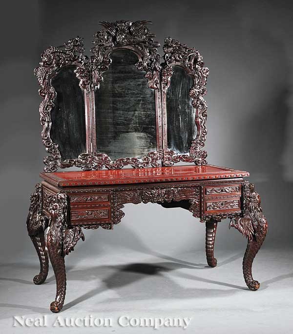 Chinese Carved Hardwood Dressing Table: An Antique Chinese Carved Hardwood Dressing Table, the three part mirror crested with a phoenix and flanking dragons, rectangular top, shaped apron with two banks of drawers, cabriole legs in the form