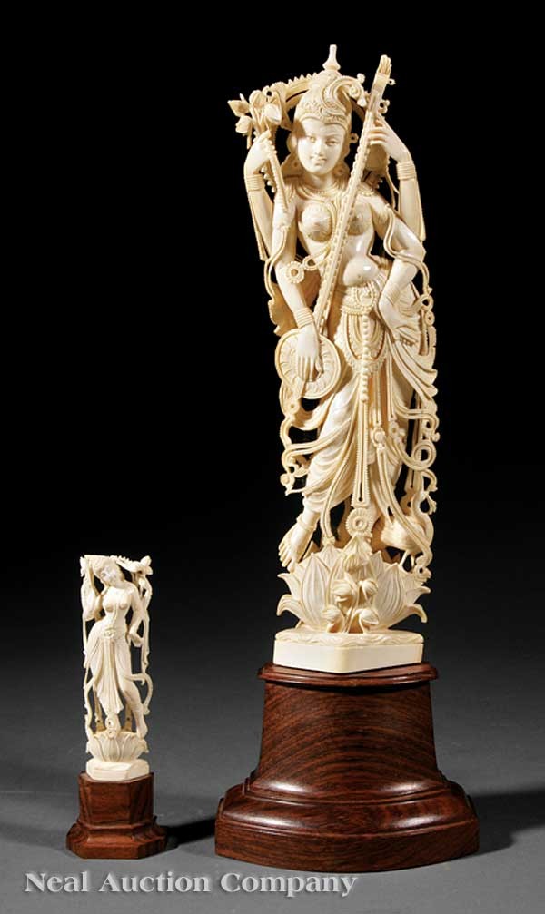 Indian or Asian Carved Ivory Figures of Parvati: Two Indian or Southeast Asian Carved Ivory Figures of Parvati, the first four armed goddess carved standing upon a lotus blossom in elegantly swayed trighanga, wearing a long undulating robe, multiple