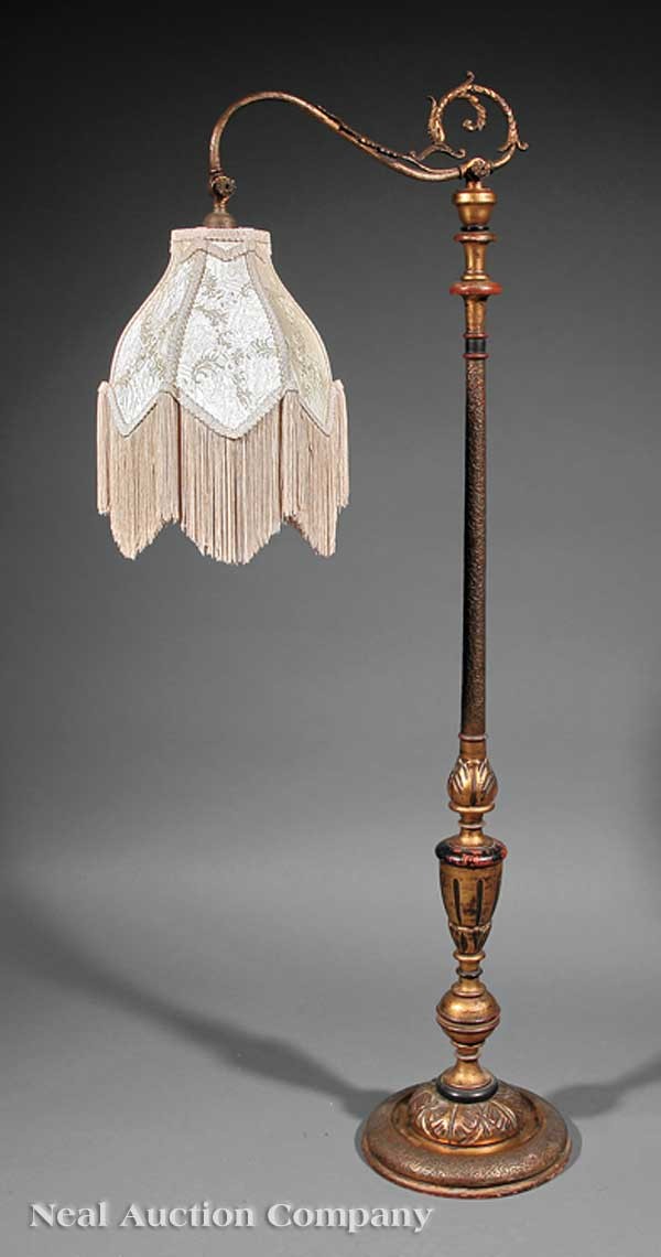 Beaux Arts Carved and Polychromed Floor Lamp: A Beaux Arts Carved and Polychromed Floor Lamp, c. 1900, adjustable arm, fringed silk shade, height 55 in.; together with a Beaux Arts-style brass torchere floor lamp, 20th c., reeded standard on trip