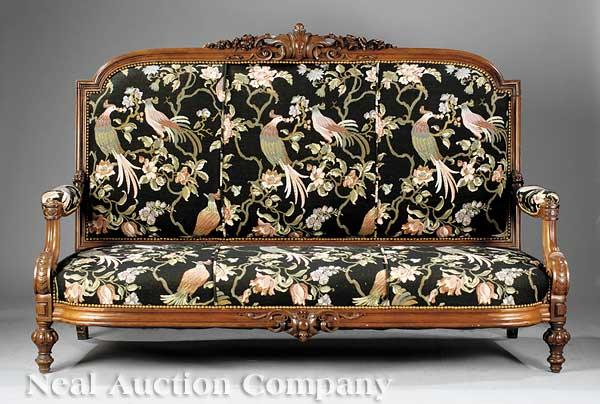 American Renaissance Carved Rosewood Settee: An American Renaissance Carved Rosewood Settee, c. 1870, arched molded crest centered by an ancanthine cartouche with floral sprays to the sides, padded arms with scroll supports, rounded conforming s