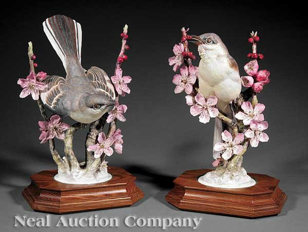 A Pair of Royal Worcester Dorothy Doughty Birds: A Pair of Royal Worcester Dorothy Doughty Porcelain Mocking Birds, each modeled perched upon flowering peach branches, raised on circular bases set within rectangular wood plinths, heights 11 3/8 in. 