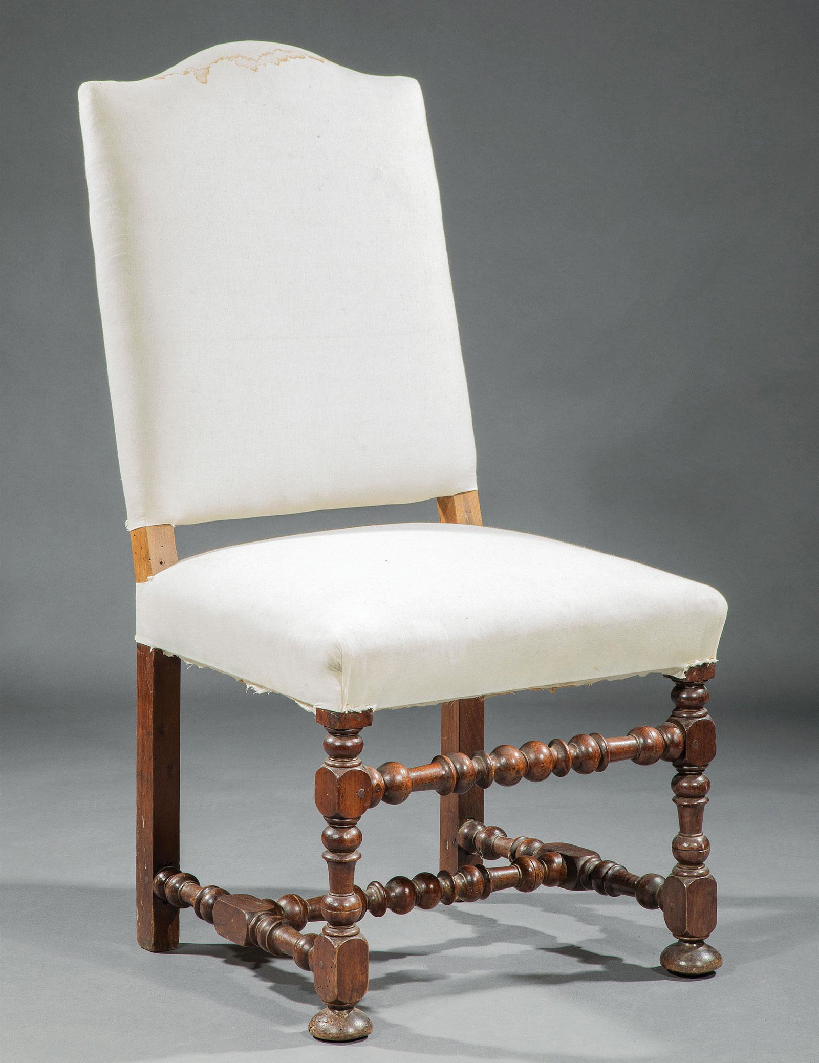 French Provincial Carved Fruitwood Hall Chair: French Provincial Carved Fruitwood Hall Chair in the Louis XIV Taste, probably 19th c., serpentine crest, padded back and seat, turned and blocked legs and stretchers, disc feet , h. 42 1/2 in., w. 21