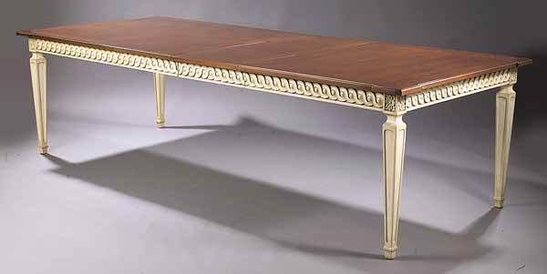 LouisXVI-Style CremePeinte Dining Table: A Louis XVI-Style Creme Peinte Dining Table , 20th c., having a walnut top, above a guilloche carved skirt, raised on molded square tapered legs, height 29 1/2 in., width 44 in., length 72 in., leaves