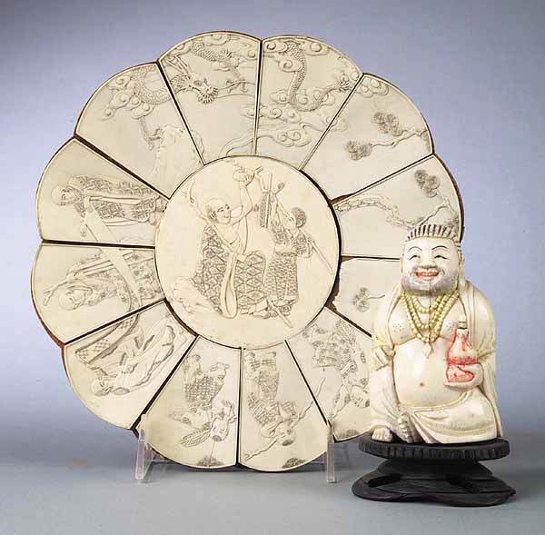 2 Chinese Buddist Carved Ivory Objects: Two Chinese Buddist Carved Ivory Decorative Objects , including an early 20th c. statuette of a smiling Buddha on a wooden base, height 5 in., and an antique lobed plate set with twelve finely carved
