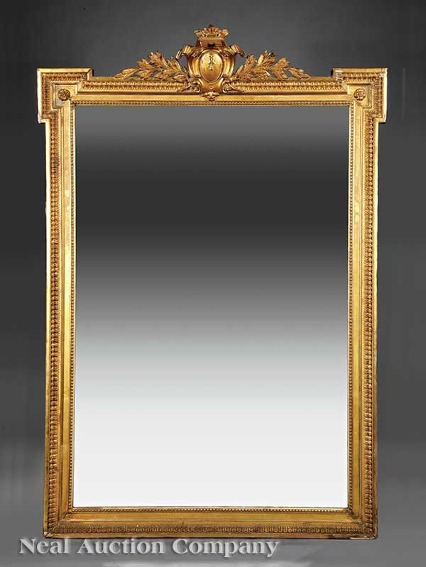 Louis XVI-Style Giltwood Overmantel Mirror: An Antique Louis XVI-Style Giltwood Overmantel Mirror, 19th c., blocked crest surmounted by a cartouche and leaf sprays, beaded and molded frame, original gilt surface, height 66 in., width 45 1/2 in