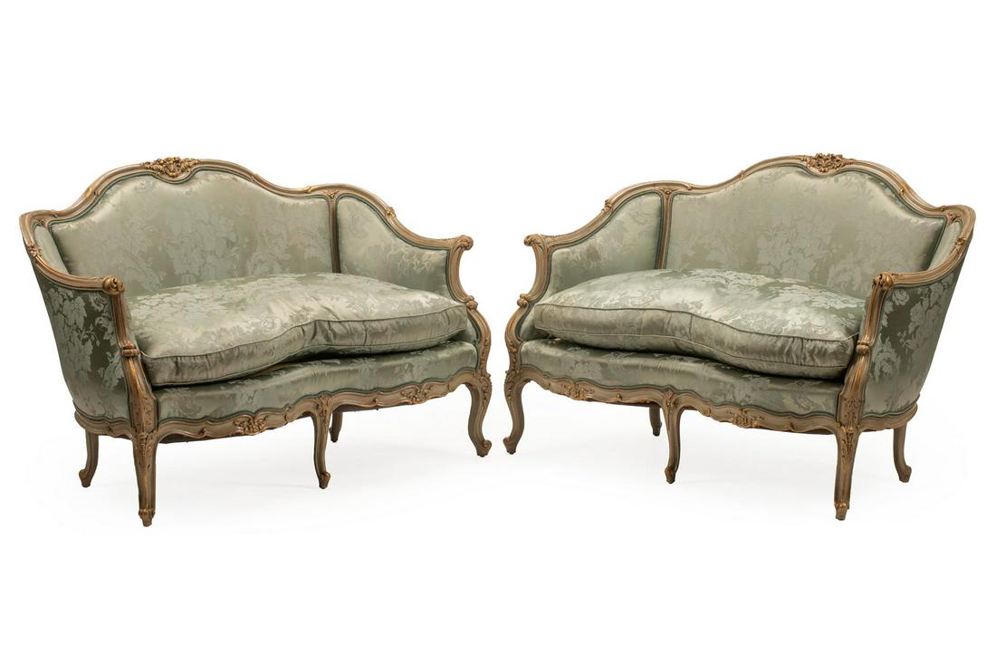 Painted and Parcel Gilt Settees: Pair of Louis XV-Style Painted and Parcel Gilt Settees, serpentine crest rail with floral decoration, molded arms with acanthine terminals, cabriole legs, damask upholstery, h. 35 in., w. 51 in., d. 2