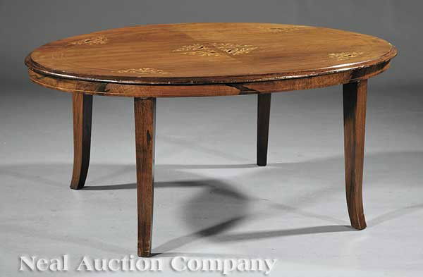 English Inlaid Mahogany Loo Table: An Antique English Inlaid Mahogany Loo Table, now a coffee table, oval top inlaid with flowering urns, conforming skirt, saber legs, height 20 1/2 in., width 46 in., depth 34 in