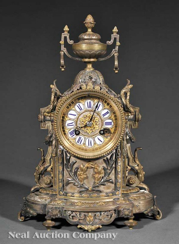 French Gilt Bronze Mantel Clock: An Antique French Gilt Bronze Mantel Clock, late 19th c., urn finial, the dial with inset porcelain numerals, allover scroll, rosette and foliate decoration, height 13 in., width 8 1/2 in., depth 5 in