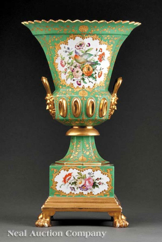 French Gilt and Polychrome Porcelain Urn: A French Gilt and Polychrome Porcelain Urn, in the style of Jacob Petit, green ground, scalloped rim, masque handles, reserves of flowers and birds, rectangular plinth base on paw feet, height 14 1/2