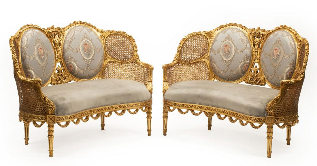 Louis XVI-Style Giltwood Settees: Pair of Louis XVI-Style Giltwood Settees, floral-carved caned and cushion back, swagged seat rail, tapered legs, h. 37 in., w. 52 in., d. 20 in