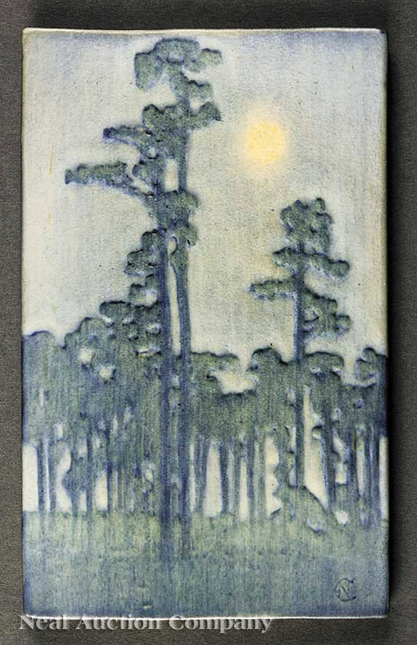 Newcomb College Art Pottery Matte Glaze Plaque: A Newcomb College Art Pottery Matte Glaze Plaque, 1915, decorated by Sadie Irvine, with a landscape of pine trees and moon, blue and green underglaze, retaining the original paper label, marked with N