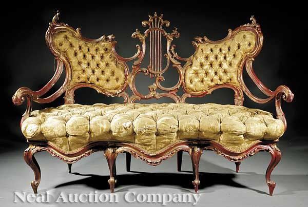 "Breakfast at Tiffany's" Settee: The "Breakfast at Tiffany's" Antique Italian Rococo Red-Painted Settee, mid-19th c., having a winged upholstered back centered by a scrolled lyre, sweeping scroll arms, scalloped serpentine seat raise