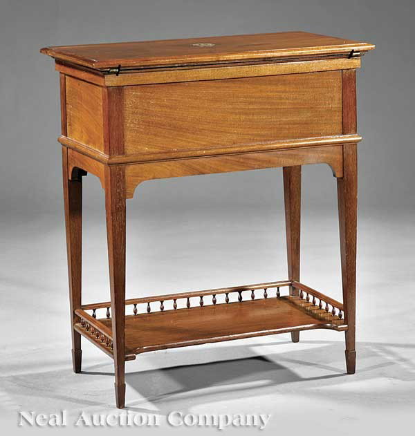 Maple & Co. Mahogany Mechanical Action Desk: An Edwardian Mahogany Mechanical Action Desk, c. 1910, labeled Maple & Co., the top with silver monogram and opening to a raised compartment and writing surface, square tapered legs joined by stretche