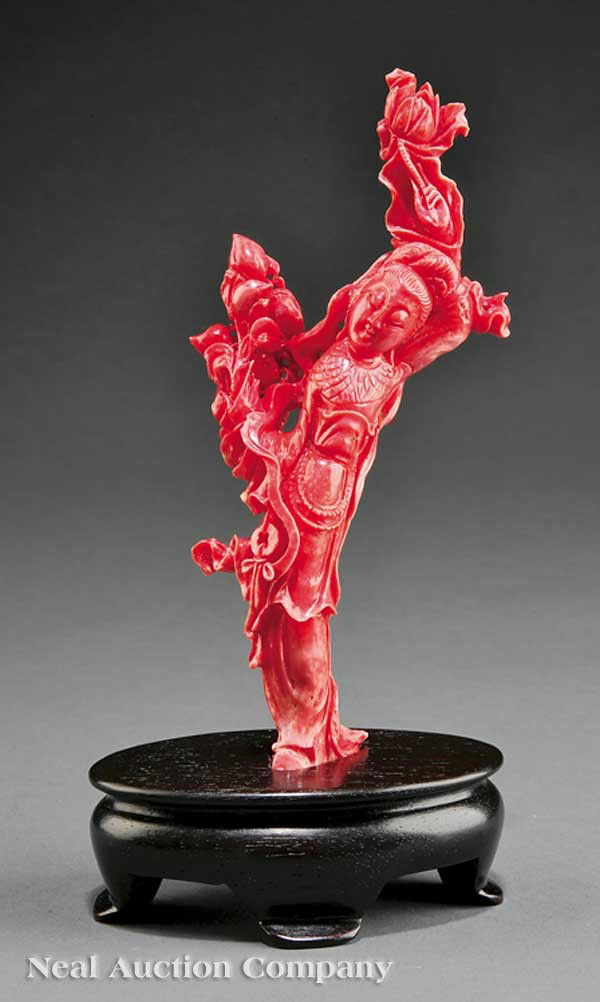 Chinese Coral Figure of a Beautiful Maiden: A Chinese Coral Figure of a Beautiful Maiden, elegant standing figure carved wearing long flowing robes and holding a lotus flower in one hand above her head and carrying a fruiting peach spray in the