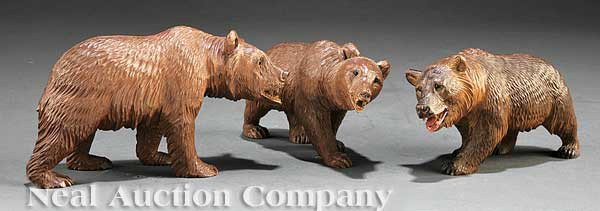 Three Black Forest Carved Bears: A Suite of Three Small Black Forest Carved Bears, inset glass eyes, length 7 in. to 7 1/4 in