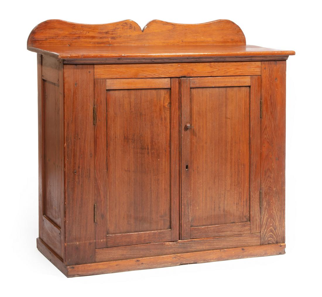 Acadian Cypress Cabinet: Acadian Cypress Cabinet, early 19th c., shaped backsplash, plank top, paneled cabinet doors, plinth base, h. 42 1/2 in., w. 44 in., d. 19 1/2 in. Provenance: Estate of Reuel Lacy "Sonny" and June Ann 