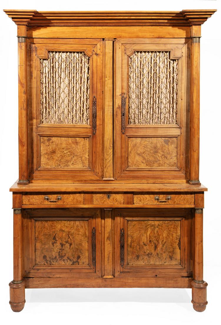 Bronze-Mounted Fruitwood and Burlwood Bookcase: Empire Bronze-Mounted Fruitwood and Burlwood Bookcase, early 19th c., stepped cornice, columnar stiles, grillework doors, two frieze drawers centered by a letter drawer, paneled cabinet doors, turned 