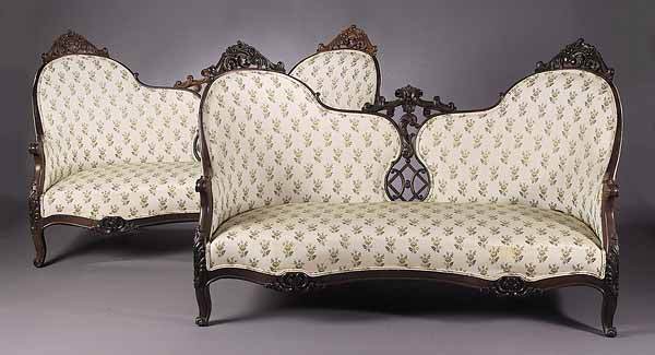 Pair of American Rococo Carved Rosewood Settees: A Fine Pair of American Rococo Carved Rosewood Settees , mid-19th c., each having a pierced serpentine back with floral and scroll crests, serpentine seat rail with acanthus carved cabriole legs, heig