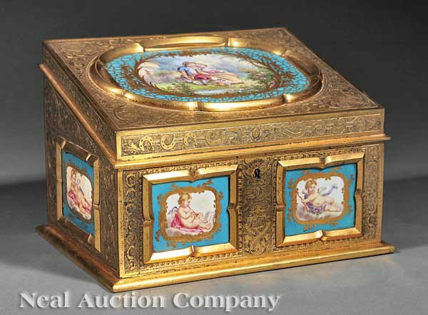 Gilt Bronze and Sèvres Porcelain Stationery Box: A Napoleon III Gilt Bronze and Sèvres Porcelain Stationery Box, c. 1870, entire surface chased with foliate and bird motifs, inset with one large and four small porcelain plaques painted with a court