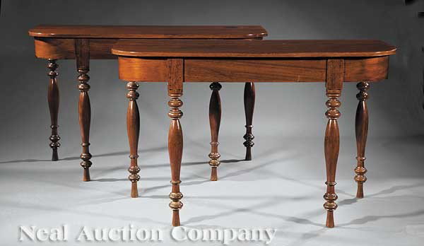 West Indies Carved Courbaril Console Tables: A Pair of West Indies Carved Courbaril Console Tables, c. 1820, Martinique, each curved top over plain frieze, on distinctively turned legs ending in modified hoof feet, height 29 1/8 in., width 46 1/