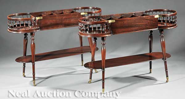 Pair Regency-Style Carved Mahogany Serving Tables: A Fine Pair of Regency-Style Carved Mahogany Serving Tables, the divided center for bottles or decanters, flanked by a demilune galleries, on ring turned legs joined by a stretcher shelf, cup casters,