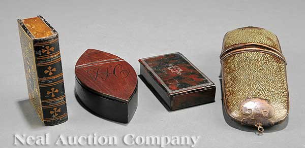Four Georgian Boxes: A Group of Four Georgian Boxes, comprising an eye-shaped mahogany box (length 5 in.), a gold and black book-shaped tin box, dated 1811 (length 3 1/2 in.), an oblong brass and shagreen spectacle case (