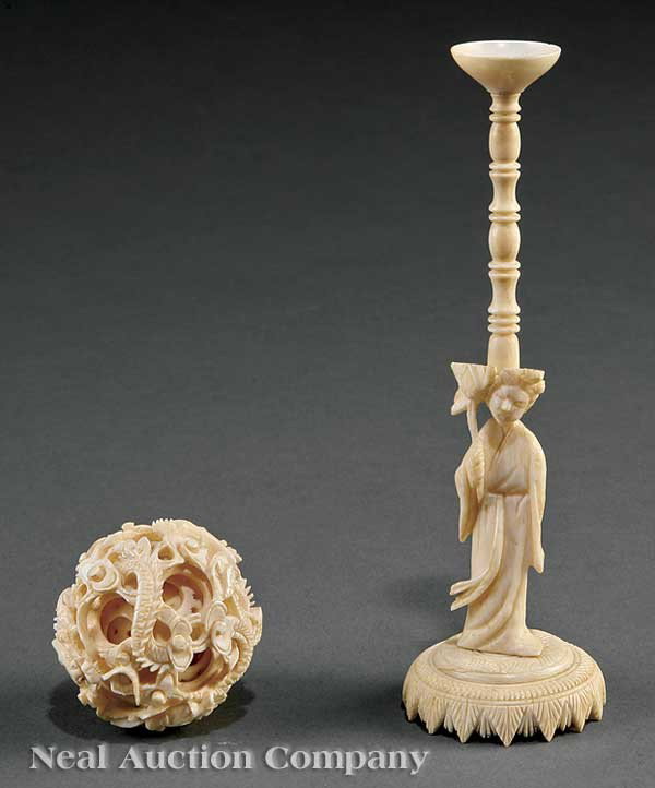 Chinese Ivory "Puzzle Ball" on Figural Stand: A Chinese Ivory "Puzzle Ball" on Figural Stand, the ball's outer casing intricately carved with writhing dragons amid ruyi clouds, the two inner balls pierced with geometric motifs, raised on a sectio