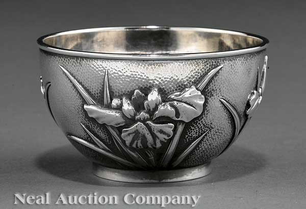 Japanese Silver Bowl: A Japanese Silver Bowl, Meiji Period, c. 1907, relief decorated with irises on a punchwork ground, base impressed "BISANSHA/SILVER" and "From/ Charles & Leana/ May 16th 1907", height 2 1/8 in., weight