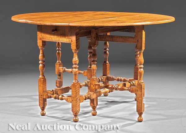 American Tiger Maple Gate-Leg Dining Table: An Antique American Tiger Maple Gate-Leg Dining Table in the Queen Anne Taste, probably 19th c., top with drop leaves over a frieze drawer, turned and blocked legs connected by stretchers, height 27 1