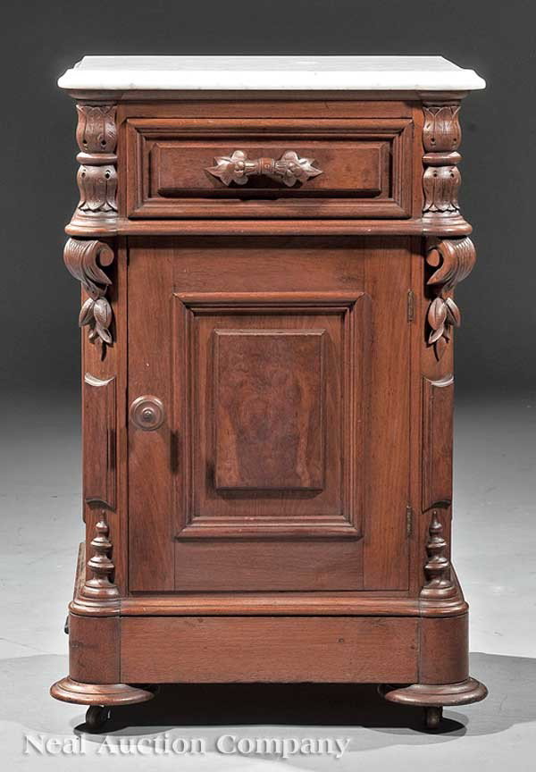 American Carved Walnut Bedside Commode: An American Renaissance Carved Walnut Bedside Commode, mid-19th c., shaped marble top, small drawer above a paneled door turreted carved stiles, disc feet, height 30 in., width 19 in., depth 17 in