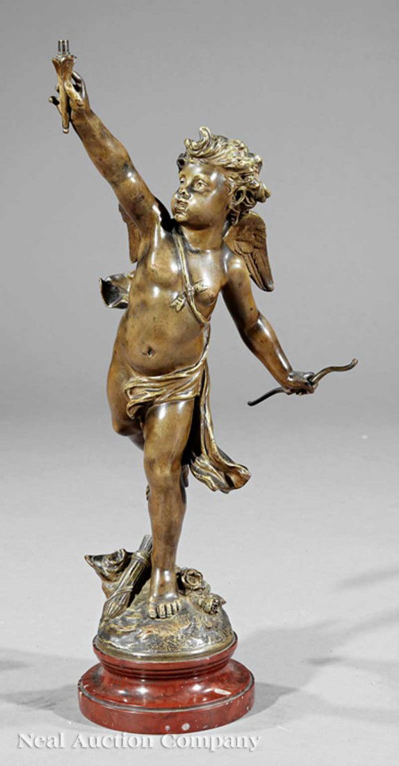 A French Bronze of Eros: A French Bronze of Eros, early 20th c., after Jean Louis Gregoire (French, 1840-1890), on rouge marble base, height 21 3/4 in. Note: Missing top portion of torch