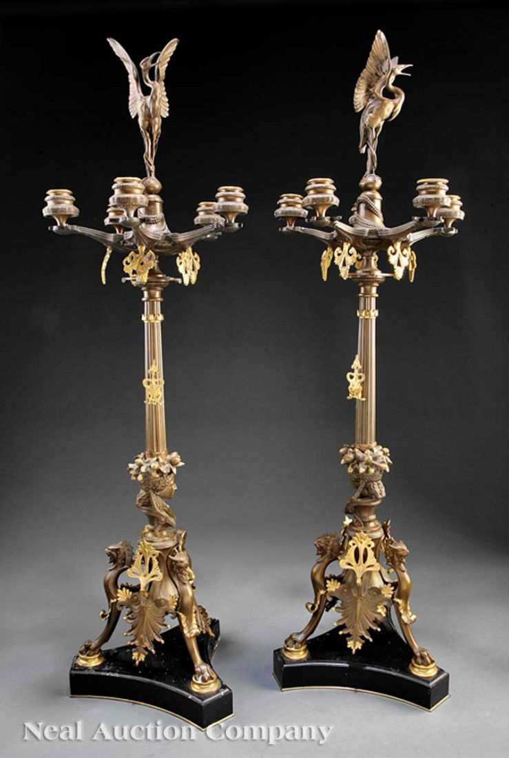 Gilt and Patinated Bronze Five-Light Candelabra: A Pair of French Gilt and Patinated Bronze Five-Light Candelabra, 19th c., each surmounted by a stork, the candle arms with gilt pendants, fluted standard ending on a bust of a classical maiden, with