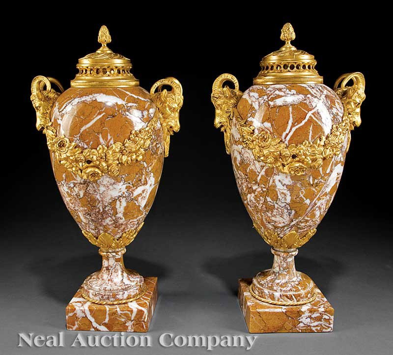 Yellow Breccia Marble Bronze-Mounted Cassolettes: A Pair of Empire-Style Yellow Breccia Marble Bronze-Mounted Cassolettes, fruit finial, ram's head handles, floral garlands, each on plinth base, height 18 in., diameter 7 in