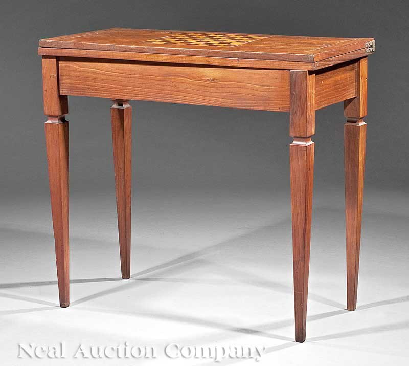 Continental Inlaid Fruitwood Games Table: A Continental Inlaid Fruitwood Games Table, c. 1790, game board inlaid fold-over top opening to a baize-lined playing surface, swivels to reveal void interior, blocked, square, tapered legs, height 30