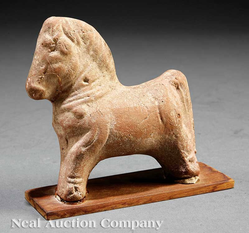 Chinese Sichuan Pottery Figure of a Horse: A Chinese Sichuan Pottery Figure of a Horse, probably Han Dynasty (206 BC - 220 AD), modeled standing with its four legs rendered in an arc, height 4 1/2 in., width 4 1/2 in., mounted to a wood plank.