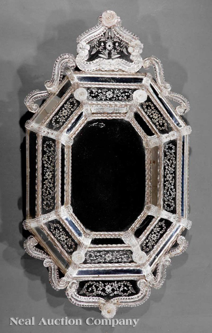 Venetian Etched Glass Mirror: An Antique Venetian Etched Glass Mirror, the segmented octagonal frame with scrolled crest, etched spiral moldings, rosette mounts, height 49 in., width 28 in