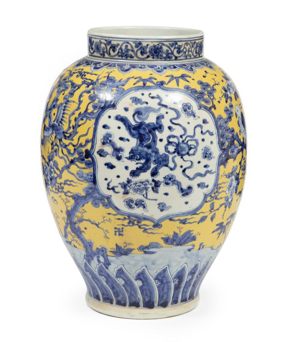 Chinese Blue and White Porcelain Yellow Vase: Chinese Blue and White Porcelain Yellow Ground Vase, 20th c., ovoid body decorated with Buddhist lion panels reserved on a floral ground, drilled base, h. 15 1/8 in.