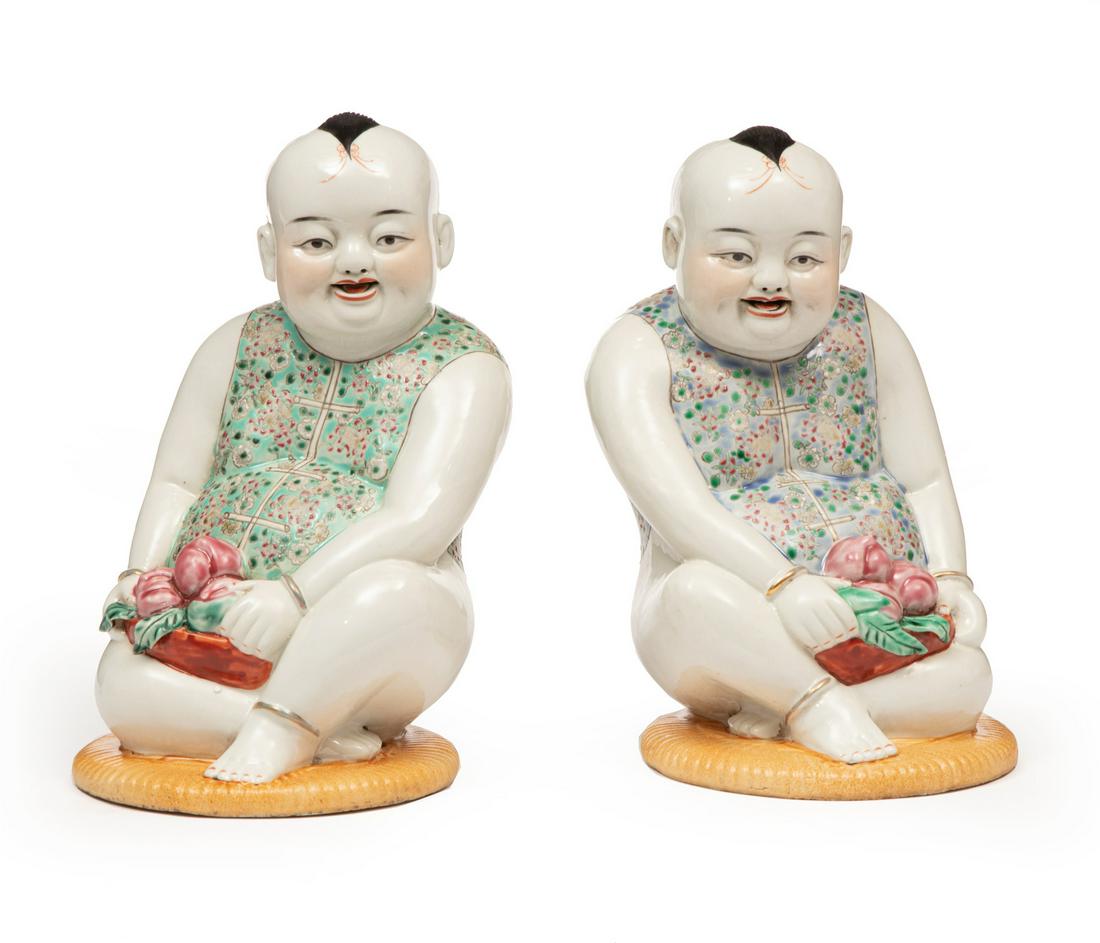 Pair of Chinese Famille Rose Porcelain Figures: Pair of Chinese Famille Rose Porcelain Figures of 'Happy Boys', modeled in mirror image, one with green vest, other with blue, each holding a basket of peaches, bases with impressed marks, h. 10 in.