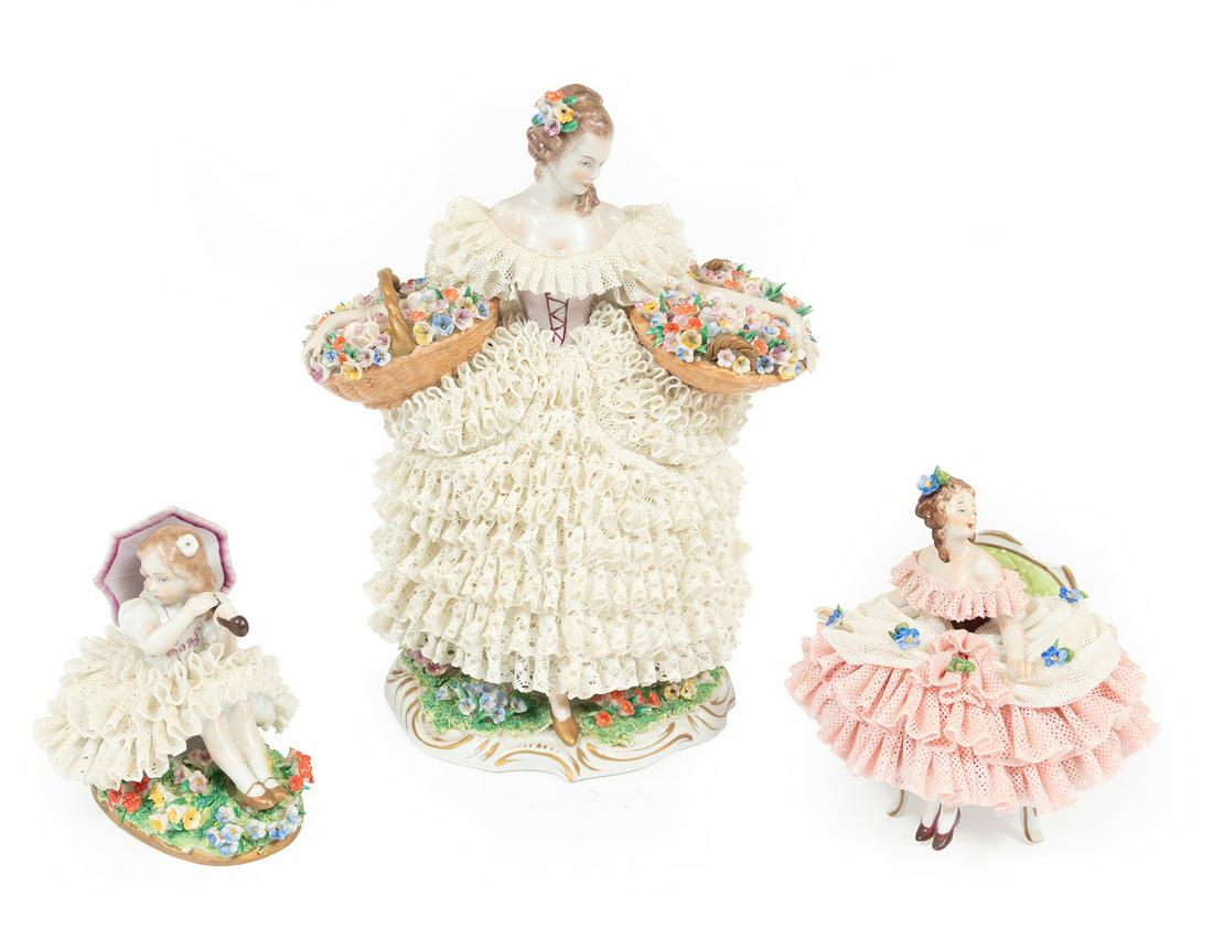 Three Volkstedt Polychrome Porcelain Figures: Three Volkstedt Polychrome Porcelain Figures of Women, marked, dressed in lace with floral accents, tallest h. 9 in. Provenance: The Schoenberger Collection, 1812 Palmer Avenue, New Orleans.