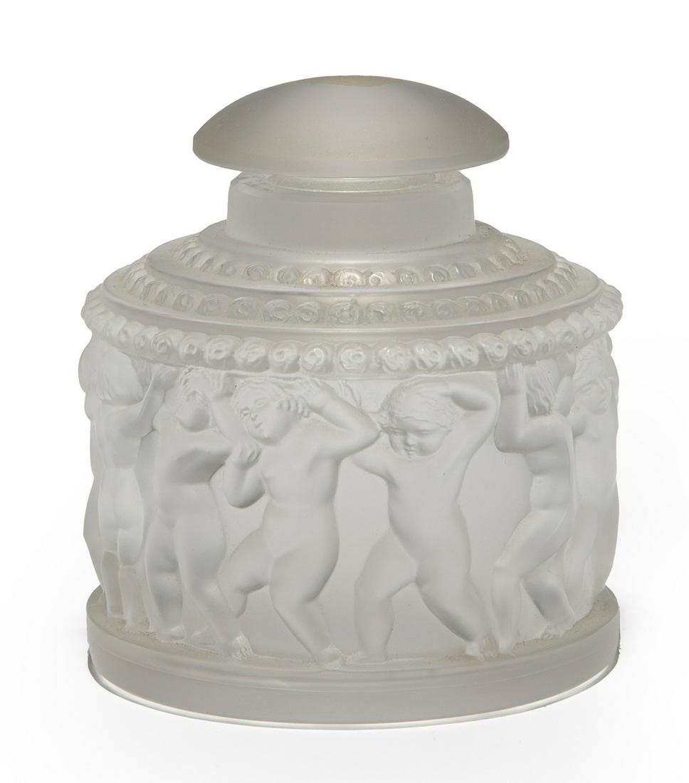 Lalique Crystal Perfume Bottle: Lalique Crystal Perfume Bottle, marked, frieze of cavorting putti, h. 4 in., dia. 3 1/2 in. Provenance: The Schoenberger Collection, 1812 Palmer Avenue, New Orleans.